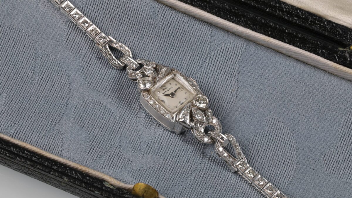 Vintage Hamilton platinum diamond watch displayed in a blue jewelry box featuring approximately 1.76 carats total weight of diamonds with a diamond band and pave diamond accents around the watch face