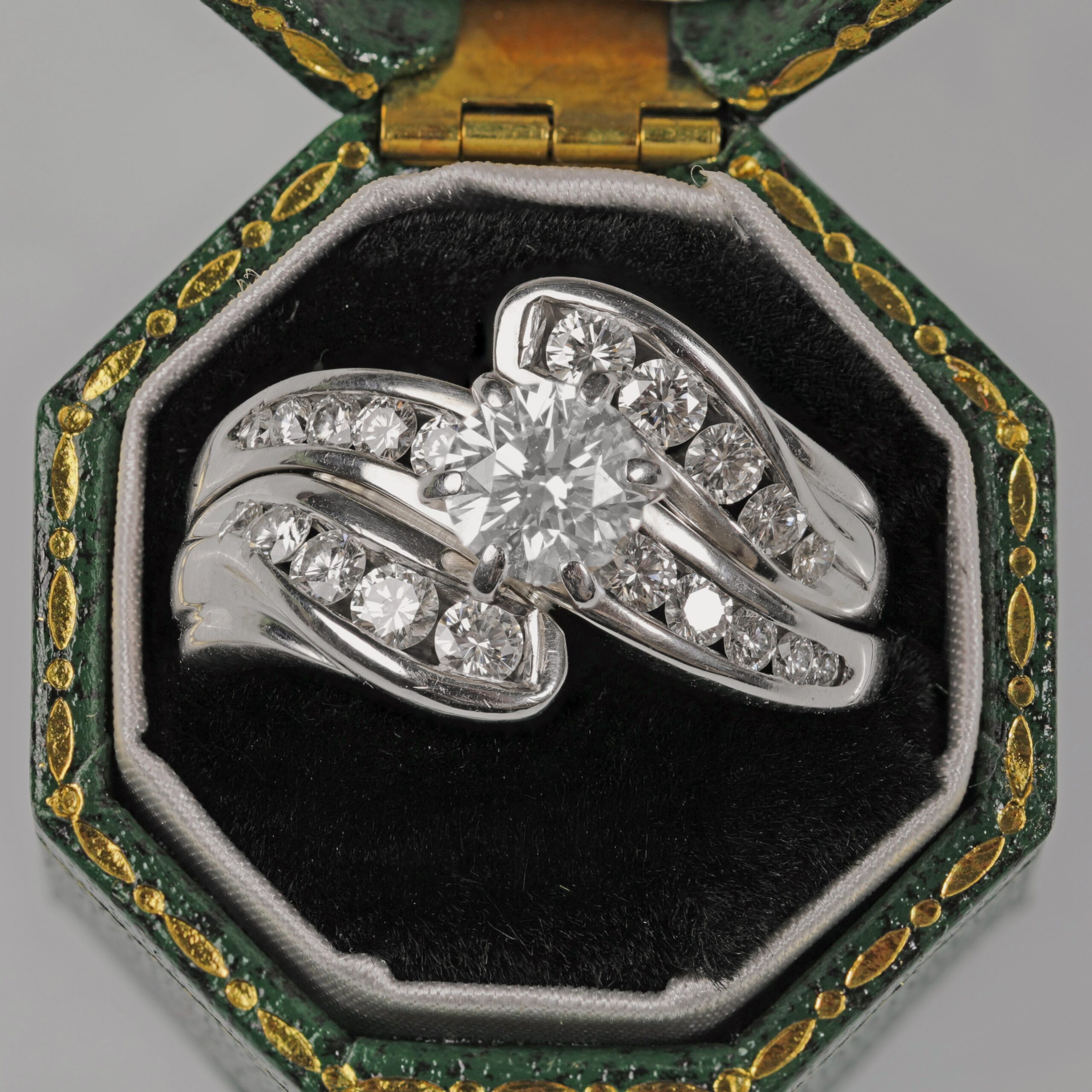 Custom 14K white gold diamond wedding ring displayed in a green ring box featuring a brilliant center diamond with channel set accent diamonds, custom made in Northern California