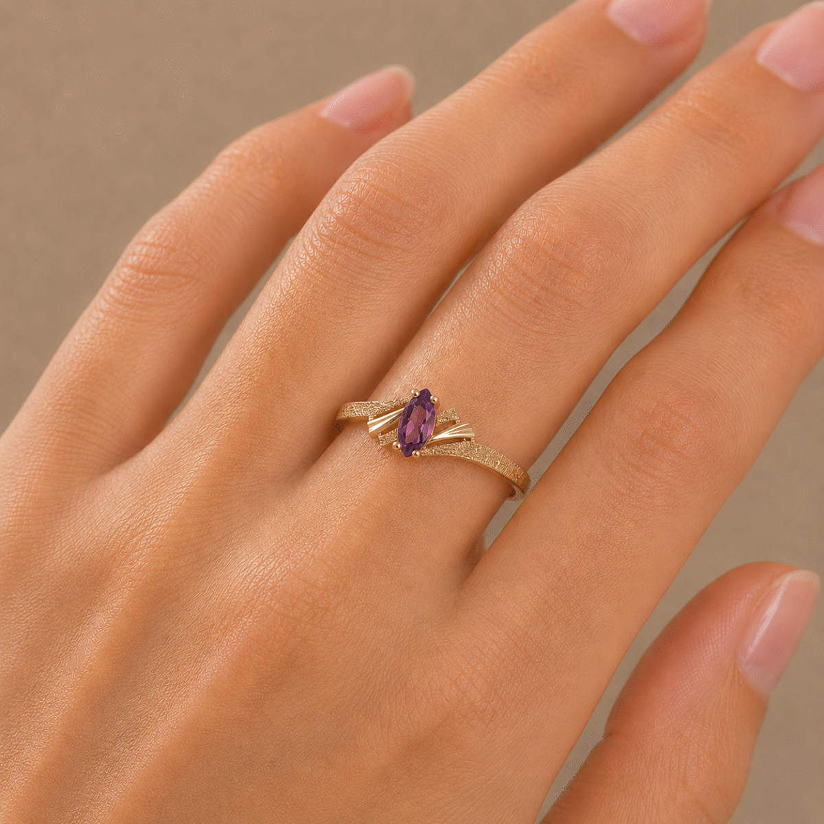 Delicate 14 karat yellow gold marquise amethyst ring on hand